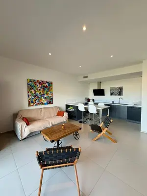 a living room with a couch and a table at Grand T2 vue mer à Propriano in Propriano