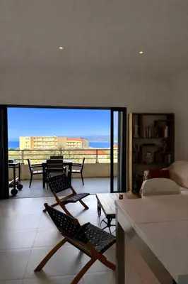 a living room with a view of the ocean at Grand T2 vue mer à Propriano in Propriano