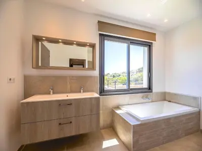 a bedroom with a large bed with two towels on it at Villa Diciottu in Porto-Vecchio