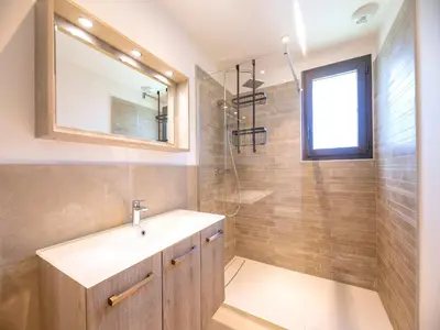 a bedroom with a large bed and a large window at Villa Diciottu in Porto-Vecchio