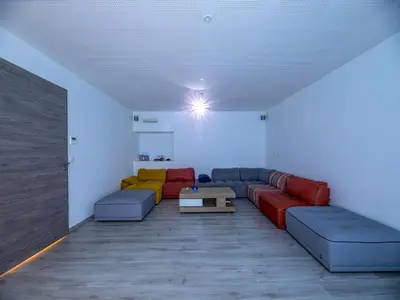 a living room filled with furniture and a book shelf at Villa Diciottu in Porto-Vecchio