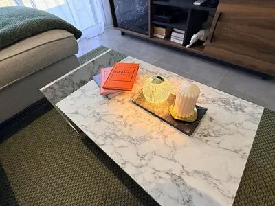 a living room with a marble table and a couch at Villa mitoyenne - Luxury house between sea and nature in Ghisonaccia