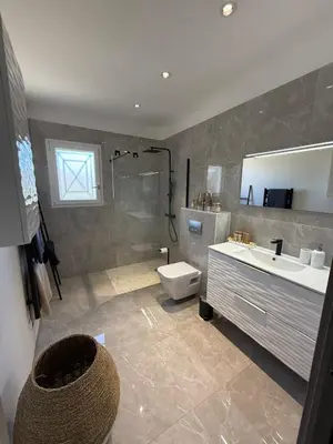 a bathroom with a toilet and a sink and a shower at Villa mitoyenne - Luxury house between sea and nature in Ghisonaccia