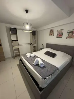 a bedroom with a large bed with towels on it at Appartement pour 6 pers avec piscine in Zonza