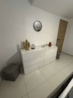 a white bathroom with a sink and a mirror at Appartement pour 6 pers avec piscine in Zonza
