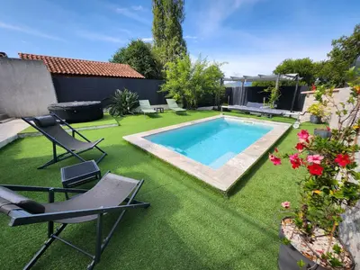 a backyard with a swimming pool and lawnitures at Haut de villa avec piscine et jacuzzi proche d'Ajaccio in Cuttoli-Corticchiato