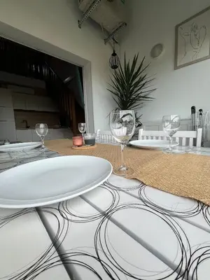 a table with wine glasses on top of it at Appartement bord de mer in San-Nicolao