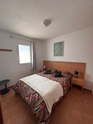 a bedroom with a bed and a window at Appartement bord de mer in San-Nicolao