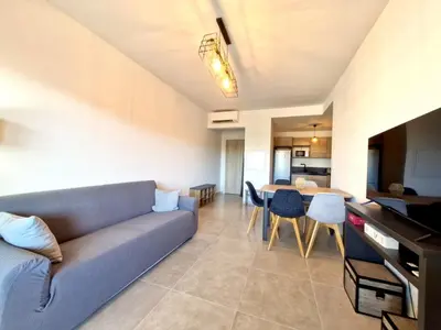 a living room with a couch and a table at Résidence Poggiarelli in Sainte-Lucie de Porto-Vecchio