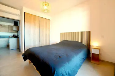 a bedroom with a large bed in a room at Résidence Poggiarelli in Sainte-Lucie de Porto-Vecchio
