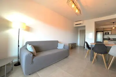 a living room with a couch and a table at Résidence Poggiarelli in Sainte-Lucie de Porto-Vecchio