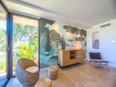 a kitchen with a wooden ceiling and white cabinets at Villa Dicianove in Porto-Vecchio