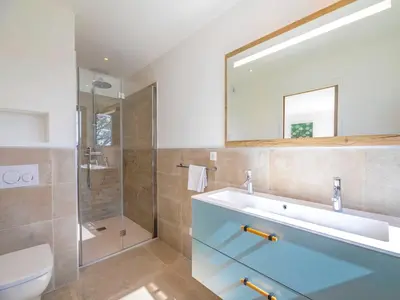 a bathroom with a sink and a glass shower at Villa Dicianove in Porto-Vecchio