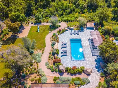a swimming pool with chairs and a house at Villa Dicianove in Porto-Vecchio
