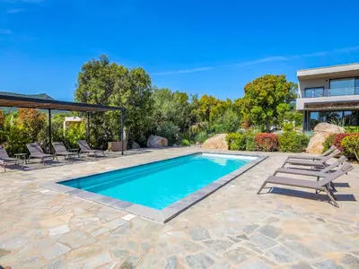 an exterior view of a house with a swimming pool at Villa Dicianove in Porto-Vecchio