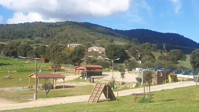 a park with a playground with a wooden ladder at Appartement de la Maison des Licornes in Appietto