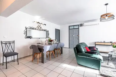 a living room with a dining room table and chairs at Le Ricci - Climatisé plages à 2 km in Ajaccio