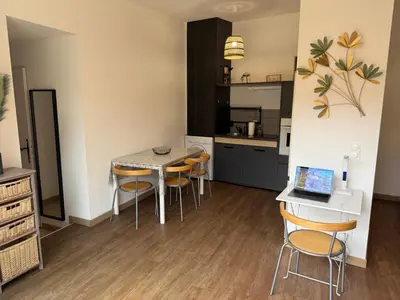 a kitchen and dining room with a table and chairs at Grand Studio hyper centre PORTO-VECCHIO in Porto-Vecchio