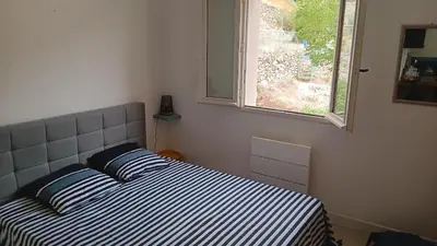 a bed in a bedroom with a window at Maison pour 6 avec piscine in Lama