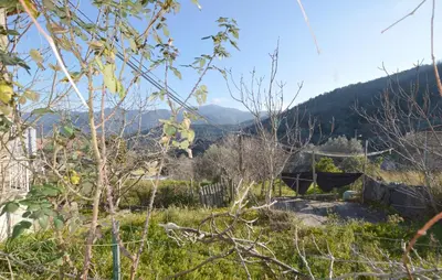 a view of a hill with mountains in the background at Maison Typique De Village in Lopigna