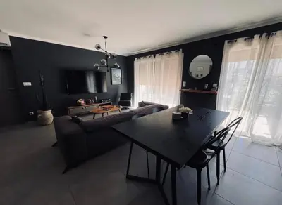 a living room with a table and a couch at Sup in Furiani