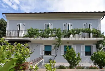 a white building with a balcony at Appart'hotel Fior Di Ribba in Sartène