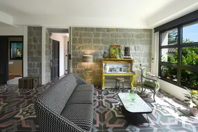 a living room with a couch and a table at Appart'hotel Fior Di Ribba in Sartène