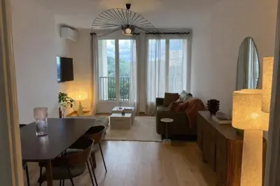 a living room with a person sitting on a couch at Ajaccio centre vue mer in Ajaccio