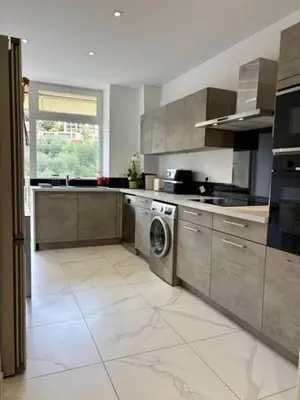 a kitchen with a washer and a washing machine at Ajaccio centre vue mer in Ajaccio