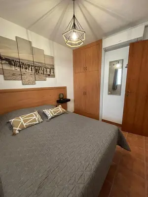a bedroom with a large bed and a light at Vacances idéales in San-Nicolao