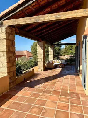 an outdoor patio with a wooden pergola at Maison 4 chambres vue mer Jardin et plage à 1 min in Olmeto