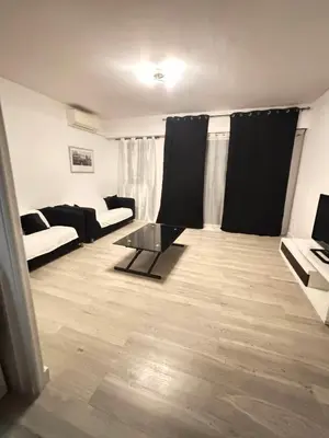 a living room with a couch and a table at Ajaccienne in Ajaccio