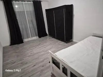 a bedroom with a bed and a wooden floor at Ajaccienne in Ajaccio