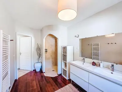 a kitchen with wooden cabinets and a sink and a window at Villa Tarabucetta by Interhome in Figari