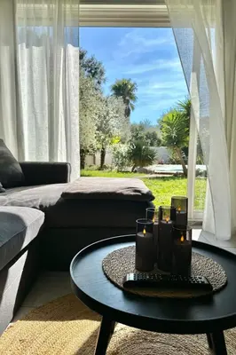 a house with palm trees in a yard at Villa Tarabucetta by Interhome in Figari