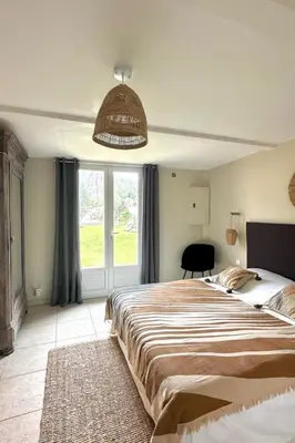 a bedroom with a bed and a tv and a window at Villa Tarabucetta by Interhome in Figari