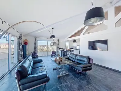 a living room with couches and a table at Apartment La Boétie by Interhome in Porto-Vecchio