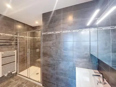 a bathroom with a glass shower and a sink at Apartment La Boétie by Interhome in Porto-Vecchio