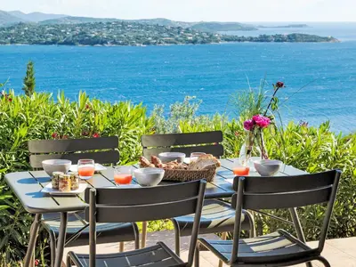 a table with a basket of food and a view of the ocean at Holiday Home Anna Maria by Interhome in Porto-Vecchio