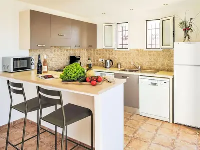 a kitchen with a counter with fruits and vegetables on it at Holiday Home Anna Maria by Interhome in Porto-Vecchio