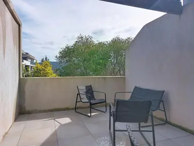 two chairs and a table on a balcony at Studio Studio Côté Sud 5 by Interhome in Porto-Vecchio