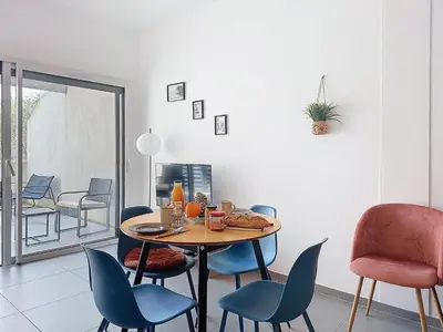 a dining room with a table and chairs at Studio Studio Côté Sud 5 by Interhome in Porto-Vecchio