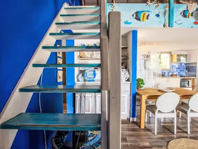 a spiral staircase in a room with a blue wall at Holiday Home Haut Casa Blue by Interhome in Sainte-Lucie de Porto-Vecchio