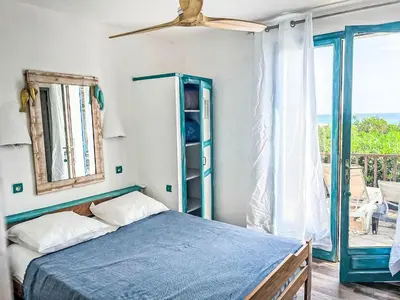a bedroom with a blue bed and a window at Apartment Bas Casa Blue by Interhome in Sainte-Lucie de Porto-Vecchio