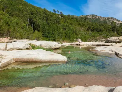 a person swimming in a body of water at Apartment Bas Casa Blue by Interhome in Sainte-Lucie de Porto-Vecchio