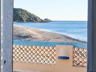 a view of the beach from a window at Holiday Home Casa Blue by Interhome in Sainte-Lucie de Porto-Vecchio