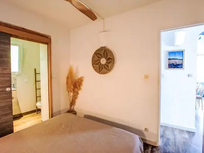a bedroom with a bed and a clock on the wall at Holiday Home Casa Blue by Interhome in Sainte-Lucie de Porto-Vecchio