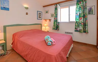 a bedroom with a red bed with a backpack on it at Villa Piscine Vue Mer in Porto-Vecchio