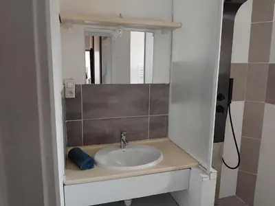 a bathroom with a sink and a mirror at villa au calme à Figari in Figari