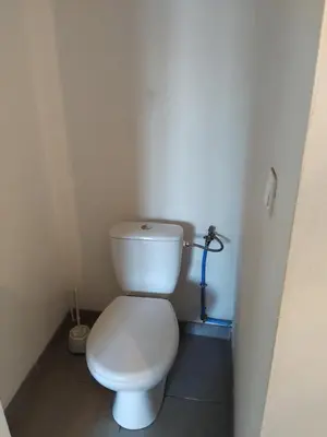 a small bathroom with a white toilet in a stall at villa au calme à Figari in Figari